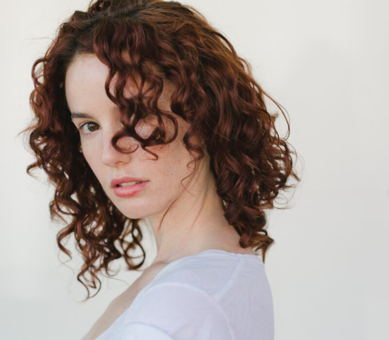 showcasing a woman's natural curly hair